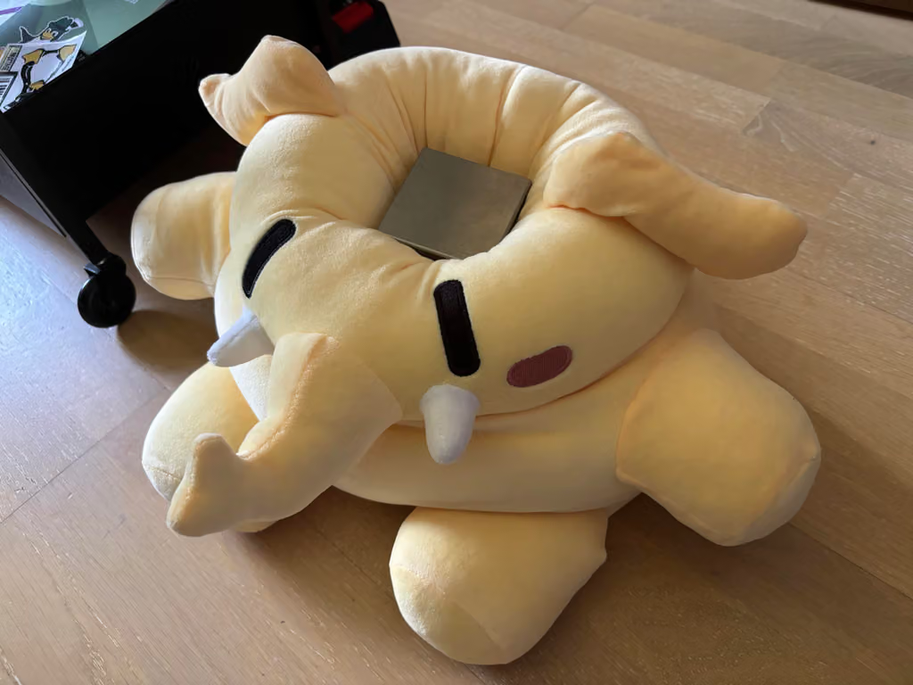 Mastodon plushie being squished by a heavy tungsten cube on its head