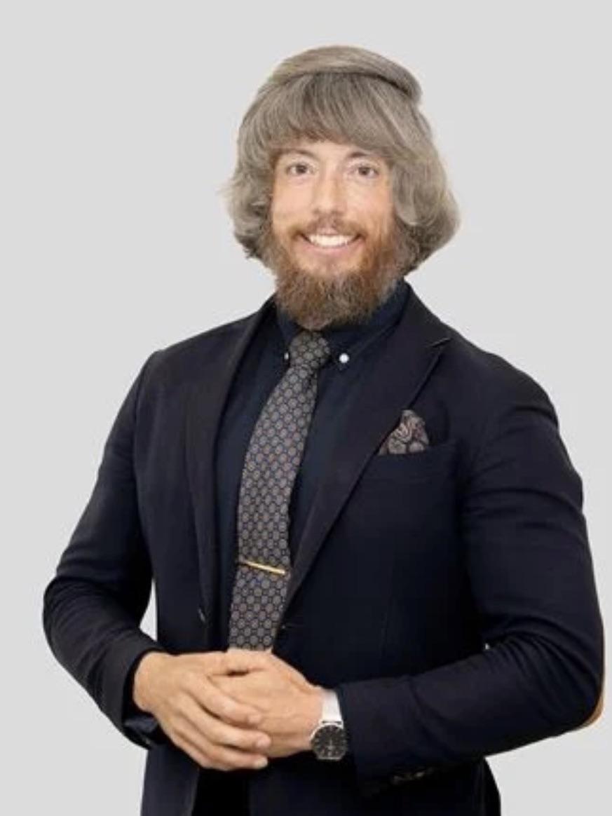 a smiling man with a weird hairdo