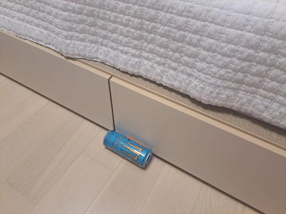 Monster energy drink right under the bed (though the bed doesn't have space below so the drink is right at the side of the bed instead)